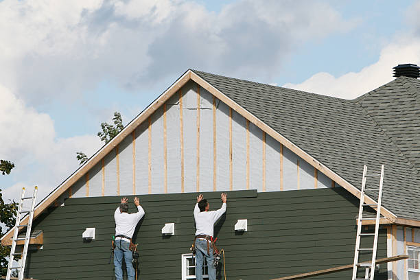 Professional Storm Damage Siding Repair technician working in Smithton, PA